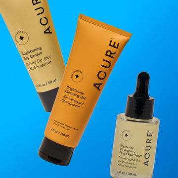 Acure skincare products including cream, gel, and serum on a blue background